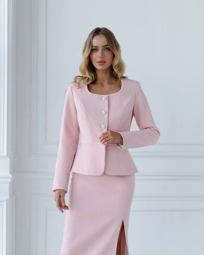 a woman in a pink dress and jacket