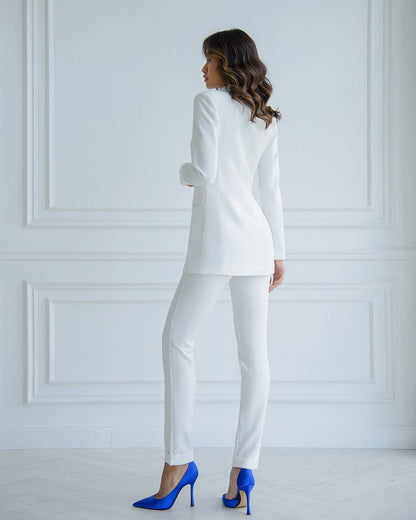 a woman in a white suit and high heels