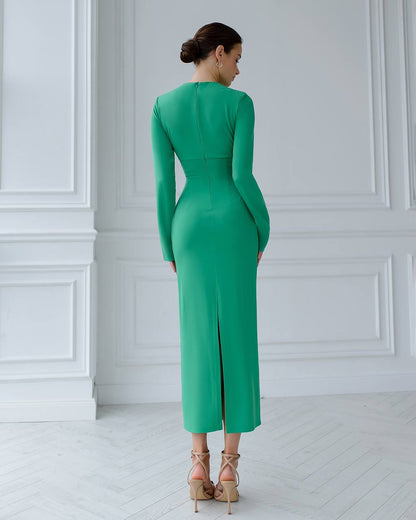 a woman in a green dress looking back