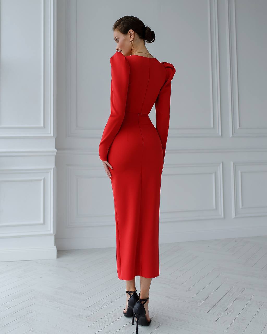 a woman in a red dress is looking back