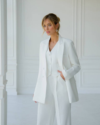 a woman wearing a white suit and jacket