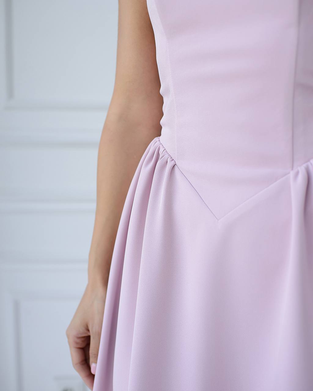 a close up of a person wearing a pink dress